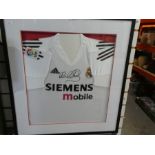 Framed and glazed real Madrid football and shirt signed by Michael Owen.