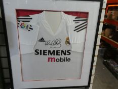 Framed and glazed real Madrid football and shirt signed by Michael Owen.