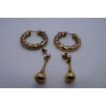 Pair of 9ct yellow gold twisted hoop earrings and a pair of pear drop earrings both marked 375, 5.7g