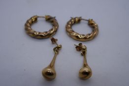 Pair of 9ct yellow gold twisted hoop earrings and a pair of pear drop earrings both marked 375, 5.7g