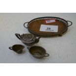 An Edwardian miniature tea service comprising of a two handled silver pierced tray, on 4 ball feet w