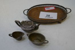 An Edwardian miniature tea service comprising of a two handled silver pierced tray, on 4 ball feet w