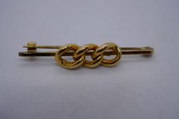 9ct yellow gold bar brooch with 3 x 15ct yellow gold links applied as decoration, 4.5cm, 4.8g approx