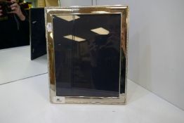 A large silver photoframe hallmarked Sheffield 1997, Carr's of Sheffield Ltd., 30cm x 25cm approx