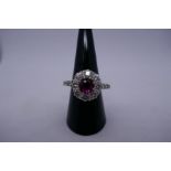 Pretty ruby and diamond cluster ring with central approx 0.5 carat round cut pinky Ruby, surrounded