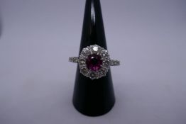 Pretty ruby and diamond cluster ring with central approx 0.5 carat round cut pinky Ruby, surrounded