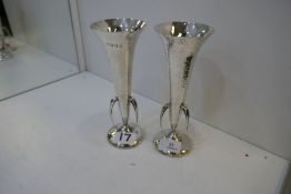 A pair of silver hammered vases in the Arts and Crafts style. Attractive items, with three handles h