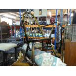 An ercol rocking chair with spindle back and circular woolen rug