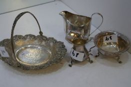 A silver lot comprising of a silver bowl with a handle, very decorated, marked 800 HST, a Georgian L