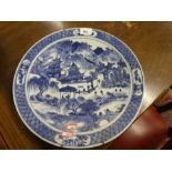 An oriental blue and white charger, probably Japanese, decorated figures in landscape, 35.5cms