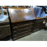 A reproduction mahogany bureau with 4 drawers