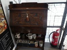 An old carved oak student bureau, having one drawer. (76cm)