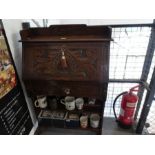 An old carved oak student bureau, having one drawer. (76cm)