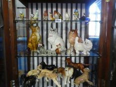 Three shelves of animals, birds and sundry. Including three Beswick cats