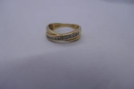 9ct yellow gold crossover design ring with 11 Channel set diamonds, Size O, Approx. 3g, Marked 375.