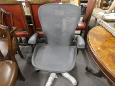 A Herman Miller, a modern Aeron desk chair on revolving base.