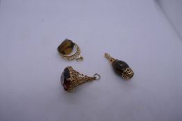 Three 9ct yellow gold seals/charms all of ornate design, two gemstone set, all marked, approx. 21.7g