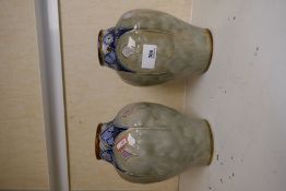 A pair of Royal Doulton stoneware vases with floral decoration, 20cms