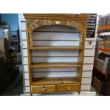 A stripped pine hanging wall shelf