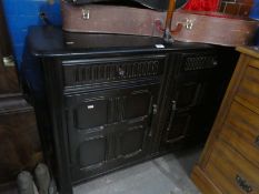 A reproduction oak sideboard having two drawers