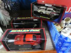 Three boxed Porche 911 Scalextric cars.