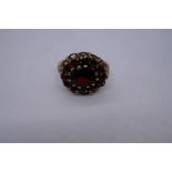 9ct yellow gold cluster ring, set with garnets, marked 375, size P, 4.4g approx