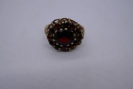 9ct yellow gold cluster ring, set with garnets, marked 375, size P, 4.4g approx