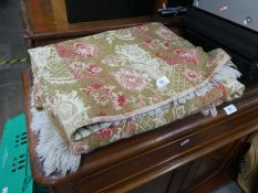 A vintage Italian bedspread, infused with a gold coloured thread and floral pattern, with decorative