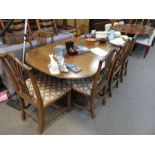 An old mahogany D end dining table having one leaf, on tripod supports, a set of 8 dining chairs wit