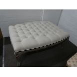 A modern French style footstool having buttoned top (104cm)