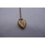 9ct yellow gold twisted rope design heel chain, hung with a 9ct heart shaped locket, chain marked 9c