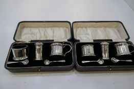 Two matching sets of silver cased salts with Bristol blue inserts. Hallmarked Birmingham 1929 Docker