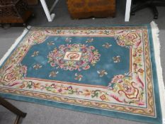 A modern Chinese rug, 204 x 140 cms, and one other small rug