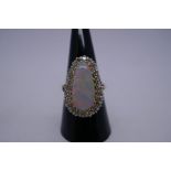 Very pretty yellow metal dress ring with pear shaped white opal with red, green and blue flashes, su