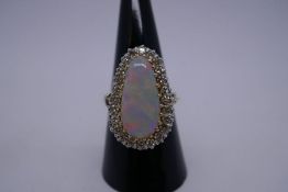 Very pretty yellow metal dress ring with pear shaped white opal with red, green and blue flashes, su