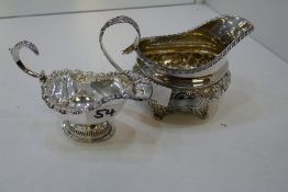A very decorative Georgian silver gilt boat, with floriated repoussed pattern on low relief with cen