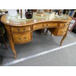 A reproduction kidney shaped writing desk having 5 drawers on carved legs, 139cm