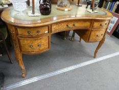 A reproduction kidney shaped writing desk having 5 drawers on carved legs, 139cm