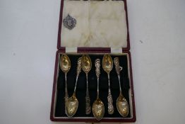 A cased set of six sterling silver teaspoons with decorative fonate patterns on the handles.