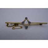 15ct yellow gold bar brooch with central diamond shape with 4 light blue sapphires and seed pearls,