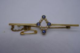 15ct yellow gold bar brooch with central diamond shape with 4 light blue sapphires and seed pearls,