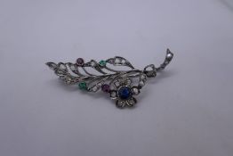Beautiful white metal brooch in the form of a spray, inset with diamonds, sapphires, rubies and emer