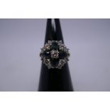 18ct white gold floral design cluster ring with central brilliant round cut diamond, 0.20 pts, encas