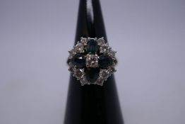 18ct white gold floral design cluster ring with central brilliant round cut diamond, 0.20 pts, encas