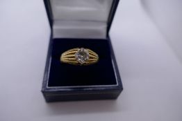 Gents yellow metal, possibly 18ct, yellow gold signet ring, set with a round cut diamond, appr