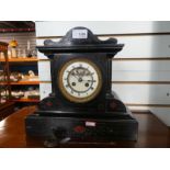 Slate mantle clock with open escarpment.