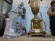 Large alabaster gilt metal lamp together with heavy carved African model of lion and father with son