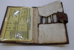 A very nice leather wallet of a garne with four silver pencils, marked 935 Germany with cards