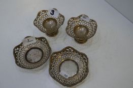 Two silver pedestal nut dishes of pierced design with beaded rim, along with a pair of matching bon