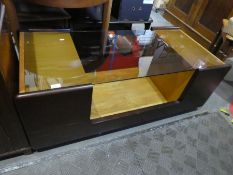 1970s style coffee table having central well with glass top